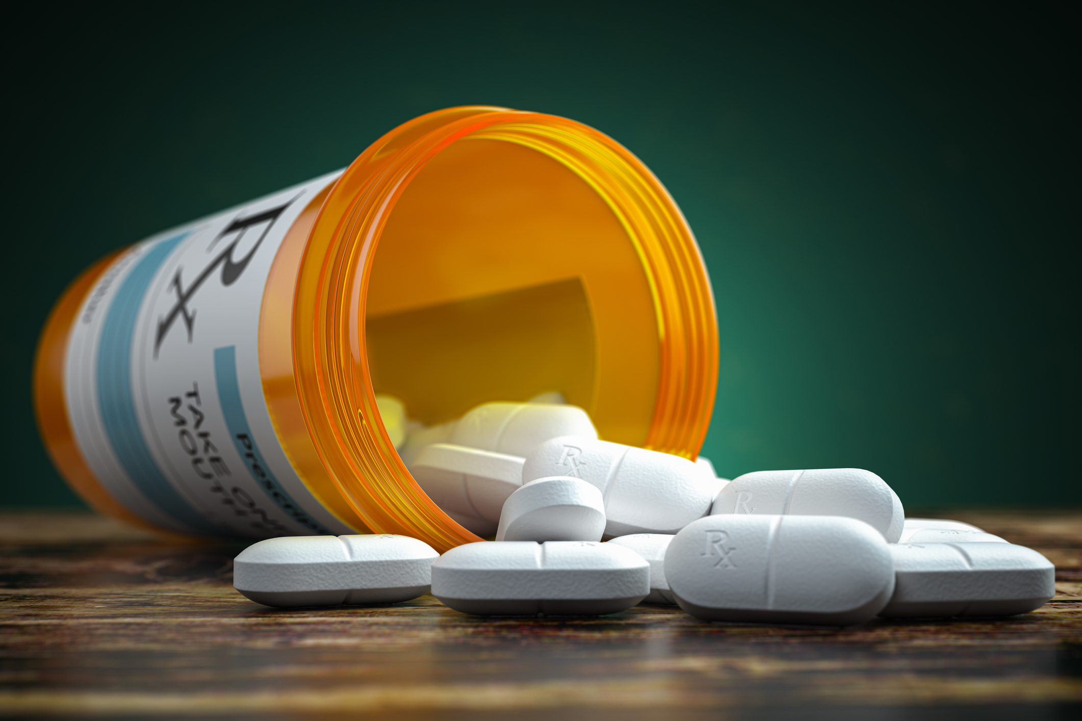 An open prescription bottle and spilled pills for antibiotic resistance blog.